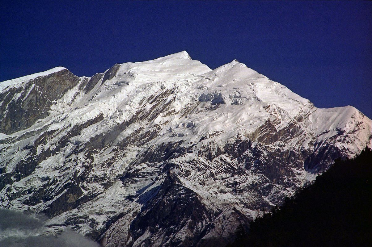 410 Tukuche Peak Early Morning From Lete Tukuche Peak in the early morning sun from Lete. Tukuche Peak (6920m) was first climbed on May 10, 1969 via the Dambush pass and northwest face by Swiss expedition leader Georges Hartmann, Alois Strictler, and Sherpa Sonam Girmi. Three days later Ruedi Homberger and Andreas Hirsbrunner repeated the ascent of the main peak.